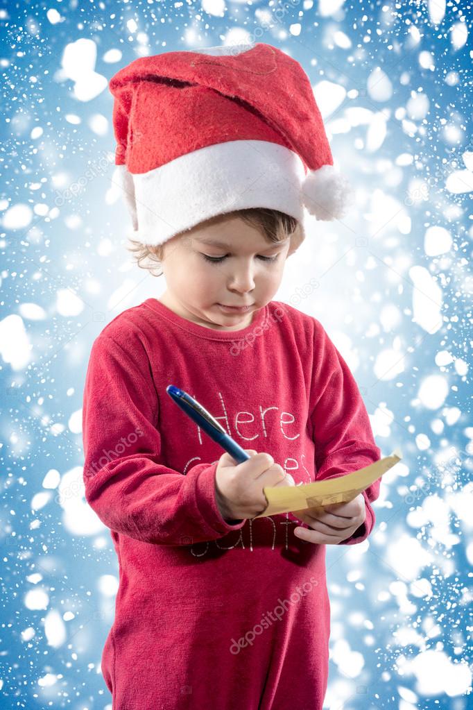 Little child holding Christmas wish list