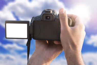 Man holding camera with blank screen