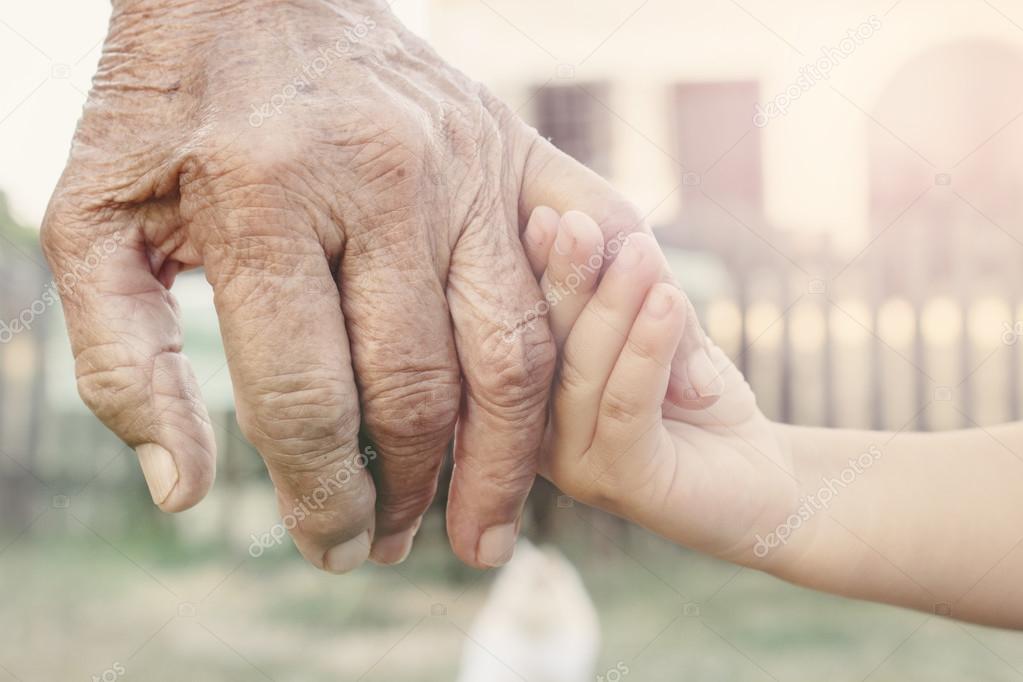 Child holding grandparent for hand