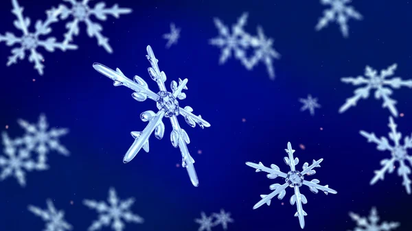 Snöflingor fokus bakgrunden blå — Stockfoto