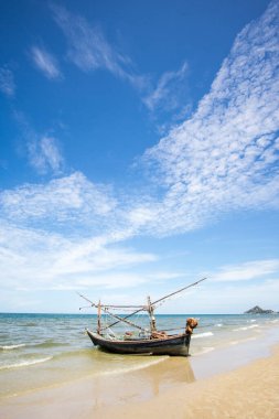 Sahilde bir balıkçı teknesi ve derin mavi arka plan, Tayland manzarası.