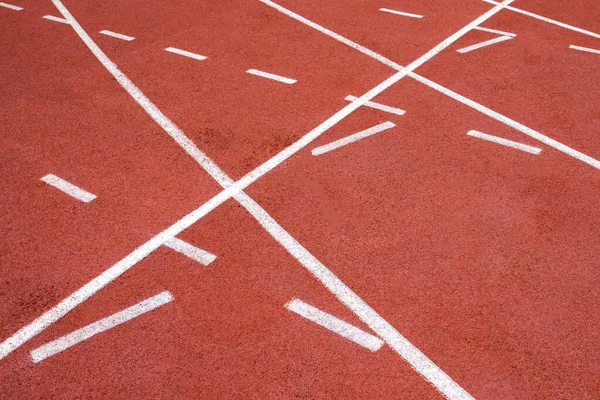 red running track on athletic stadium background texture