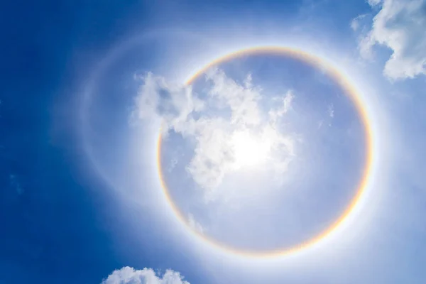 sun corona rainbow clouds and blue sky background , Circumscribed halo