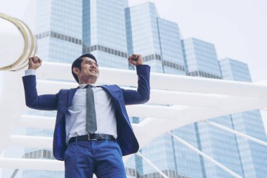 Başarılı bir iş adamı iş bölgesinde silahlarla kutlama yapıyor, iş kavramı