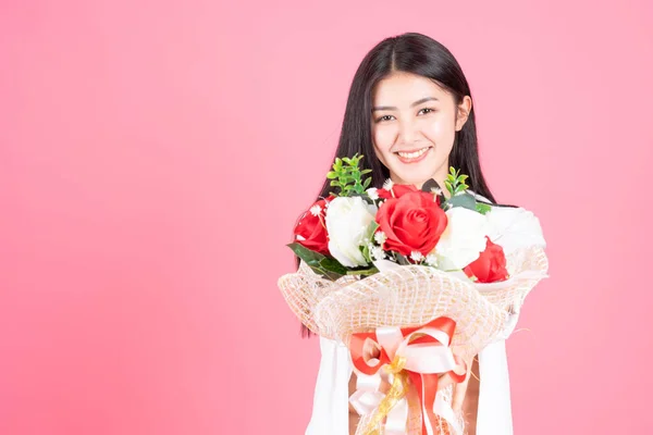 beauty woman Asian cute girl feel happy holding flower red rose and white rose on pink background - lifestyle beautiful woman