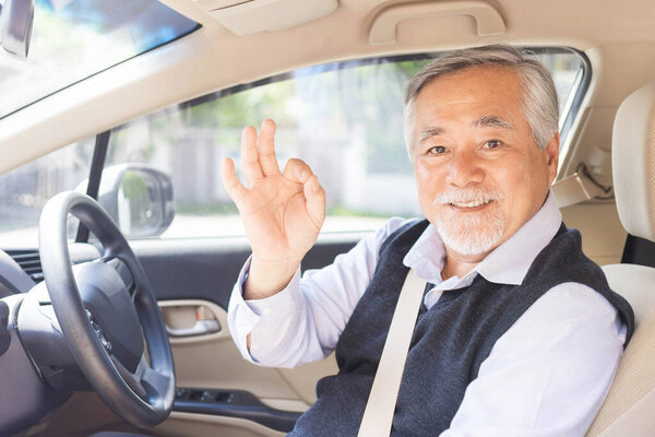 Portrait Of Smiling Asian senior man , old man , Elderly man driving a car 