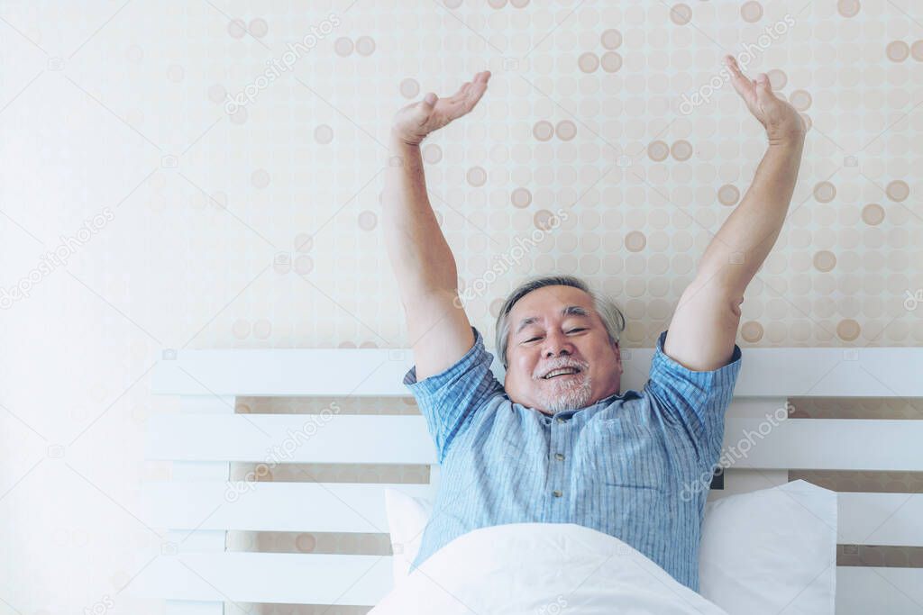 Senior man feel happy good health wake up in the morning enjoying time in his home indoor bedroom background - lifestyle senior happiness concept