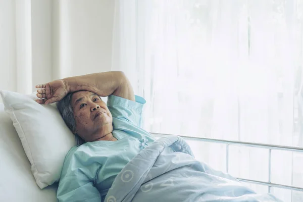 Lonely Elderly patients in hospital bed patients want to go home - medical and healthcare concept