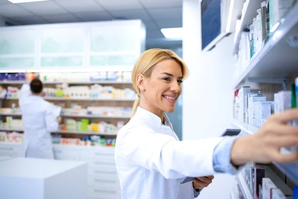 Piękna Blond Aptekarka Organizująca Leki Półce Aptece Profesjonalny Farmaceuta Pracy — Zdjęcie stockowe