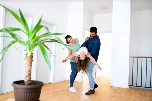 Young Caucasian Family Playing Silly Games Celebrating Moving New Home — Fotografia de Stock