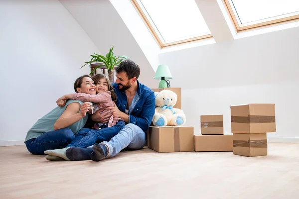 Happy Caucasian Family Hugging Each Other Celebrating Moving New Home — Fotografia de Stock