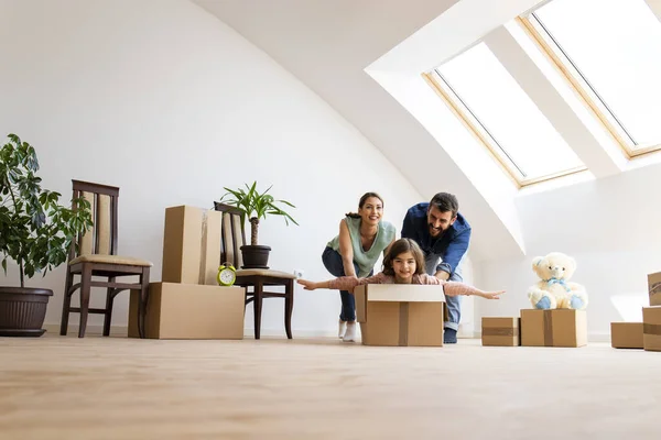 Young Happy Family Children Moving New House Riding Cardboard Box — Stockfoto