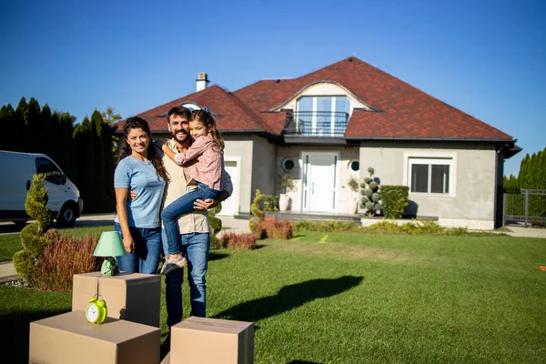 Happy family just bought a new house and moving in.