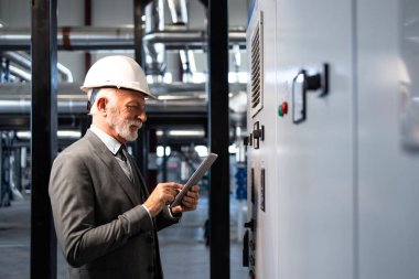 Endüstriyel kontrol paneli kullanan kıdemli mühendis