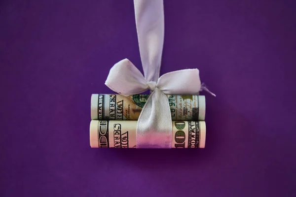 Dollar Banknotes Rolled Tube Tied White Ribbon Gift Lie Purple — Stock Photo, Image