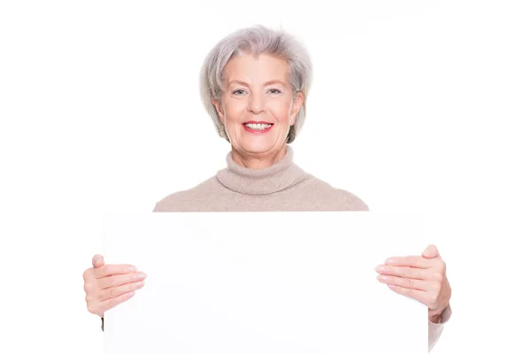 Senior woman with blank sign — Stock Photo, Image