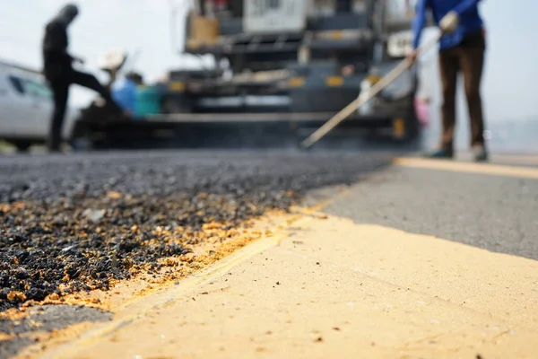 Blurred image, highway maintenance work, ASPHALT HOT MIX IN - PLACE RECYCLING.