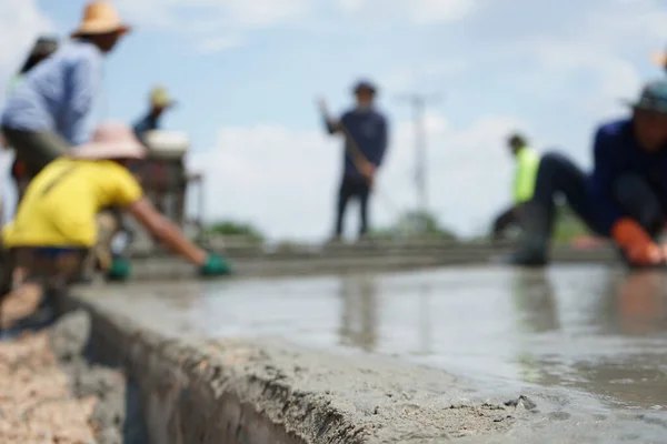 Image Blurred Workers Pouring Concrete Construction Island Middle Road — Stock Photo, Image