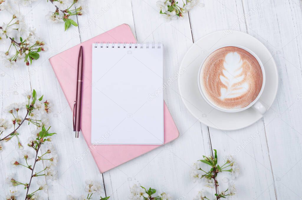 Creative flat lay of workspace desk, notepad and lifestyle objects on wooden background