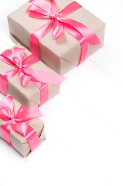 Gift boxes with bow on white wooden background. Valentine's Day, Mother's Day, March 8, World Women's Day holiday concept