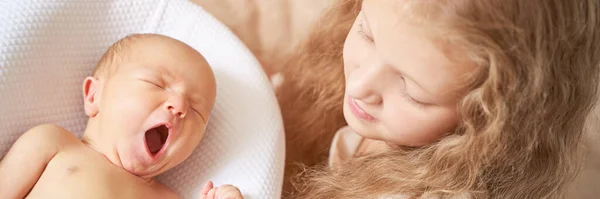 Tiny newborn. Old sister not touch little people. Healthcare massage concept — Stock Photo, Image