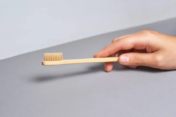 Hand holding toothbrush. Bamboo eco brush — Stock Photo, Image