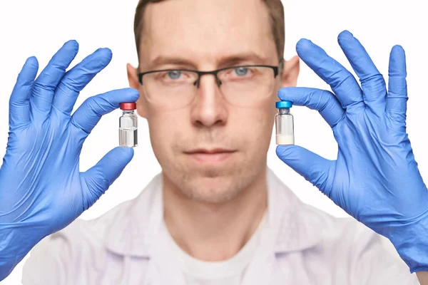 Egy férfi kék kesztyűben tartja a vakcinás üvegeket. Injekciós gyógyszertár — Stock Fotó