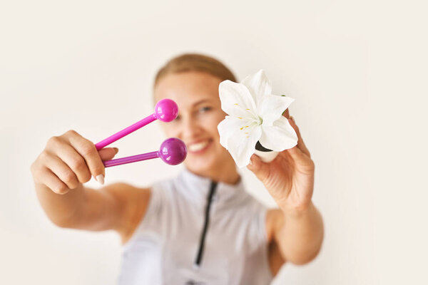 Young woman hand holding femine toys. Kegel adult exercise. Intimate gymnastics