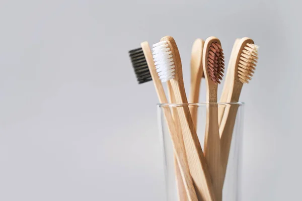 Set of ecology toothbrush on grey background. Different color glass. Diversity — Stock Photo, Image