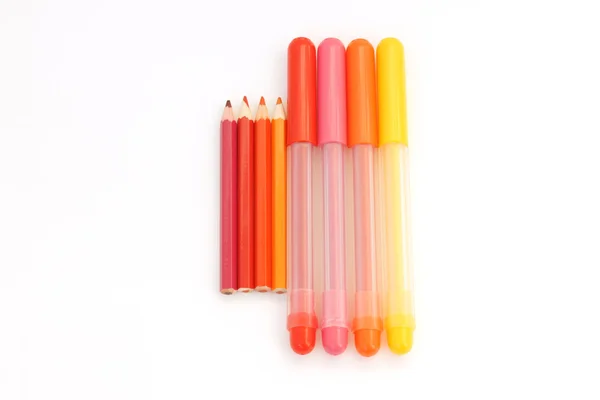 Red, orange, pink and yellow pencils and felt-tip pens. — Stock Photo, Image