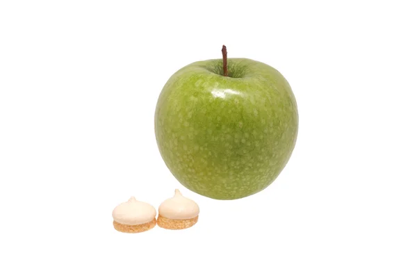 Green apple and biscuits — Stock Photo, Image