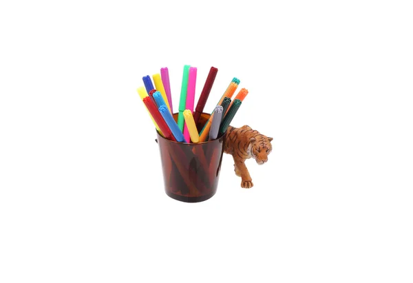 Toy tiger and crayons in a glass. — Stock Photo, Image