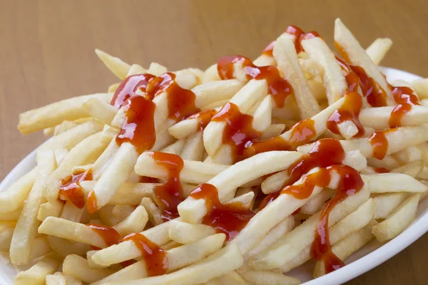 Delicious shoestring style french fries with ketchup — Stock Photo, Image