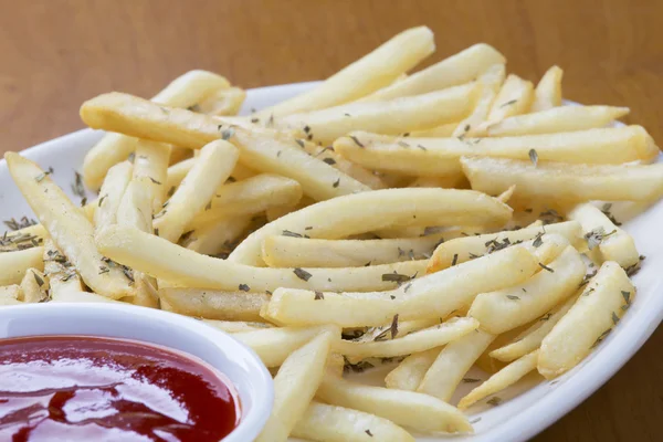 Delicious shoestring style french fries with ketchup — Stock Photo, Image
