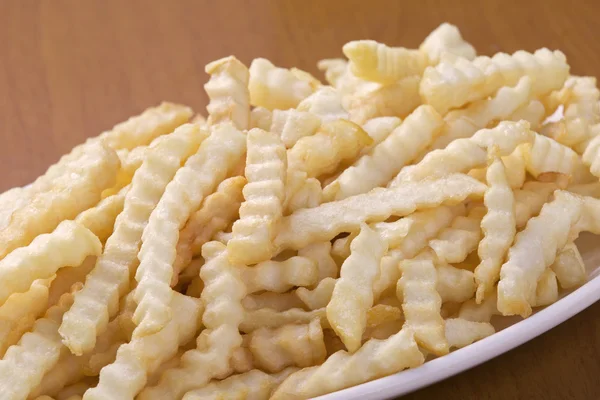 Delicious crinkle cut style french fries — Stock Photo, Image