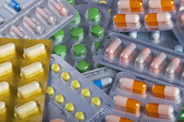 Bakgrunnsfotomontasje med fargerike piller og kapsler av moderne medi – stockfoto