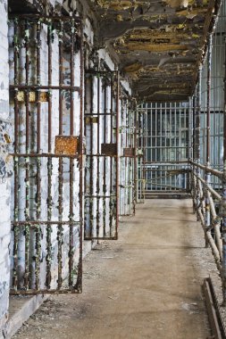 Cell block of the inside of an old prison no longer in use clipart