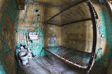 Cell block of the inside of an old prison no longer in use clipart