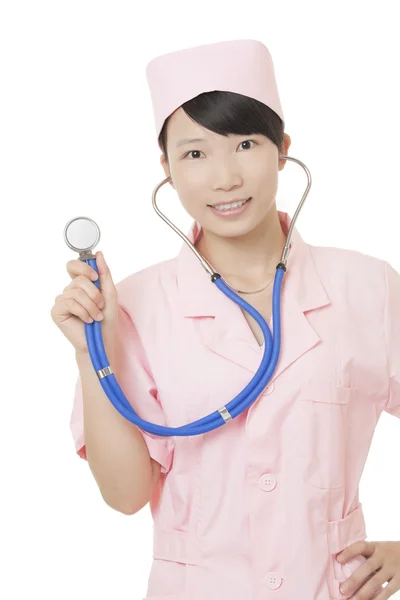 A portrait of a beautiful Asian nurse holding a stethoscope isolated on a white background — Stok fotoğraf