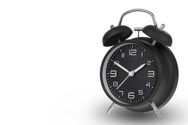 Black alarm clock with the hands at 10 and 2 am or pm isolated on a white background — Stock Photo, Image