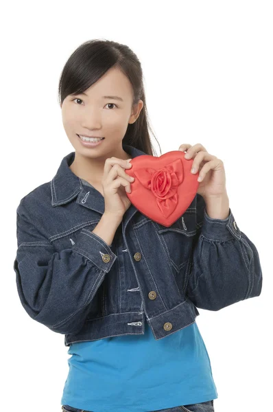 Schöne Chinesin, die ein rotes Herz hält und mit jemandem flirtet, der auf weißem Hintergrund isoliert ist — Stockfoto
