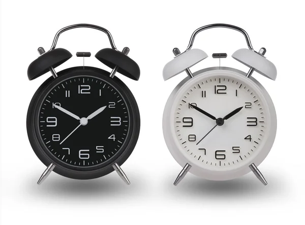 Two alarm clocks one Black and one White with the hands  set at 10 and 2 am or pm isolated on a white background with drop shadows — стокове фото