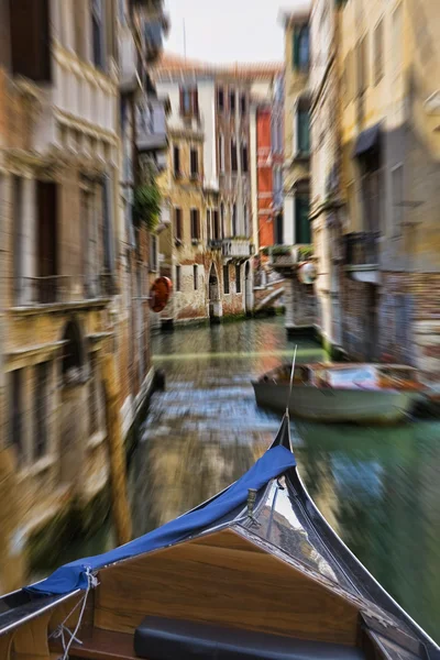 Gondola moving through one of many canals with typical Venusian architecture in Venice Italy — Stock Photo, Image