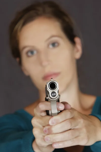 Καυκάσιος γυναίκα υπερασπίζεται τον ευατό της χρησιμοποιώντας ένα πιστόλι — Φωτογραφία Αρχείου