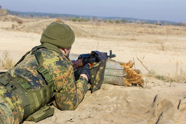 Soldier shoots from a shooting-iron, weapon