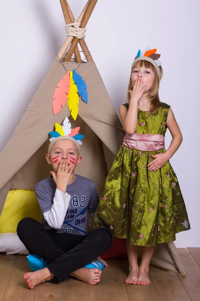 Girl and boy in carnival costumes indians studio — Stock Photo, Image