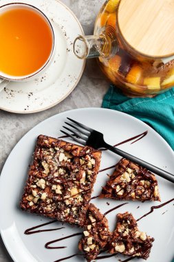 Gri arka planı kahveyle dolduran büyük waffle 'lar.