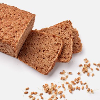 Beyaz bir tabakta dilimlenmiş çavdar ekmeği ve kabak çekirdeği. 