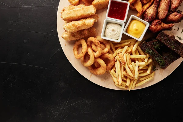 Tackler Snacks Black Textured Background Top View — Stock Photo, Image