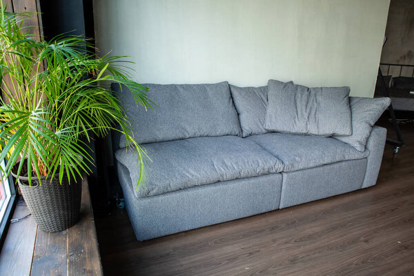 soft upholstered light sofa with modules in the interior with a panoramic window